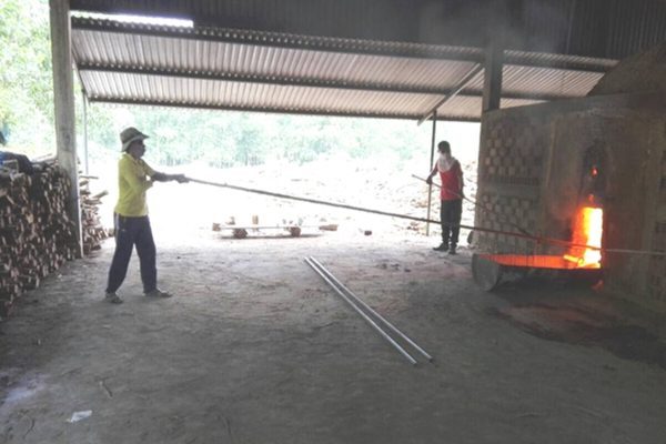 Workers tending the kiln fire